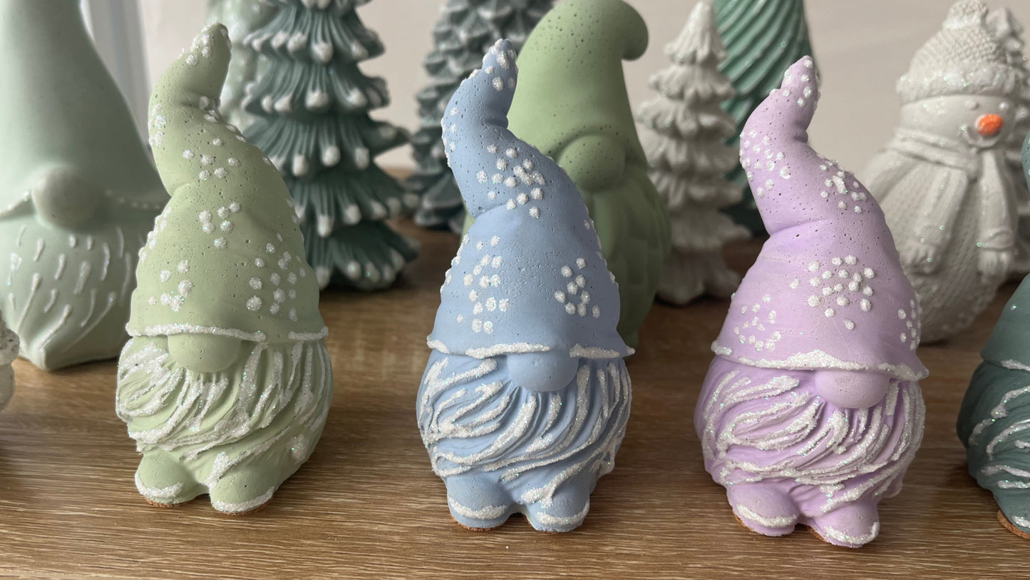Decorative cement gnomes in various colors.