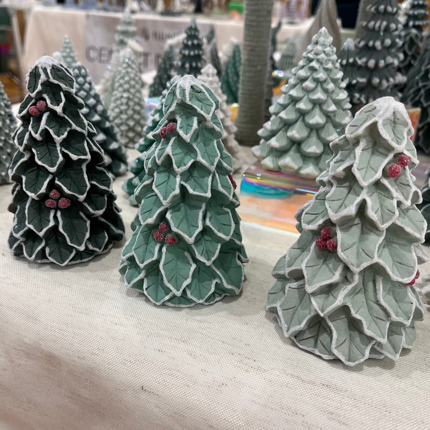 Love Nene small cement Christmas trees with holly berries hand decorated. 