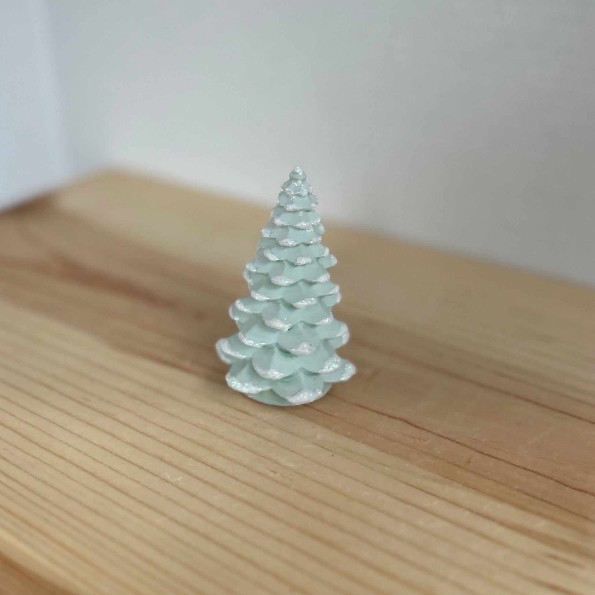 Norway Spruce small concrete Christmas tree in light green with snow details. Xmas Tree Decor by Love Nene.